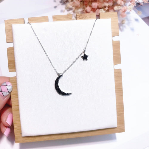 Choker style necklace with moon and star